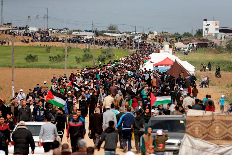 Thousands of people gathered along the Israel-Gaza Strip border where Palestinians have set up tents and were staging a march on March 30, 2018. Mahmud Hams / AFP