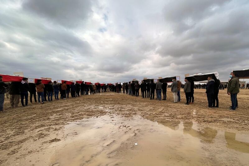 Mourners gather for the burial of the remains of 104 Yazidi victims of ISIS in Kocho, Iraq. REUTERS