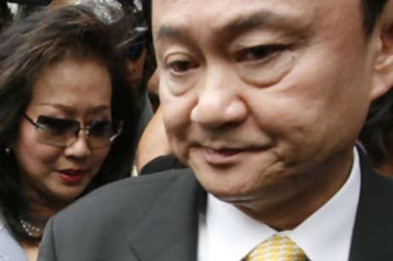 The ousted Thai prime minister Thaksin Shinawatra and his wife Potjaman Shinawatra at the criminal court in Bangkok in July.