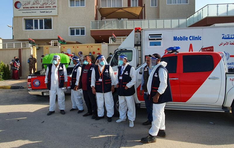 Libyan medical workers arrive to start an awareness campaing on COVID-19 at Friday market shops in the capital Tripoli. It is impossible to gauge the full extent of the epidemic in Libya, a country mired in chaos since 2011 when an uprising backed by the West toppled dictator Moamer Kadhafi. But it is clear that there has been a surge in cases in recent weeks, heaping further pressure on overburdened services.  AFP