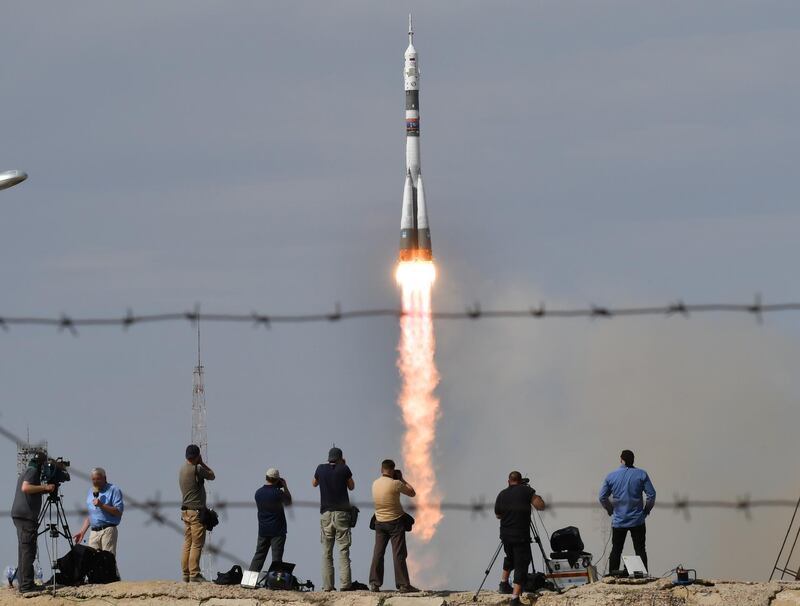 Photographers take pictures as Russia's Soyuz MS-09 spacecraft carrying the members of the International Space Station (ISS) expedition 56/57, NASA astronaut Serena Aunon-Chancellor, Roscosmos cosmonaut Sergey Prokopyev and German astronaut Alexander Gerst, blasts off to the ISS from the launch pad at the Russian-leased Baikonur cosmodrome. Vyacheslav Oseledko / AFP