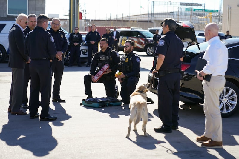 Mr Biden watches as border officers demonstrate how they search vehicles for drugs, money and other contraband. AP