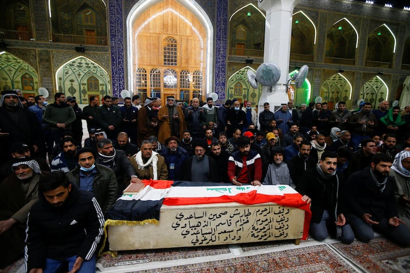 Mourners gather near the coffin of a man, who was killed in a twin suicide bombing attack in a central Baghdad market, during a funeral in Najaf, Iraq. Reuters