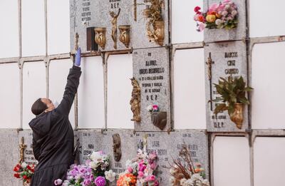 A woman wearing a face mask and gloves touches a niche during the burial of a man who died of the new coronavirus at the South Municipal cemetery in Madrid, on March 23, 2020. The coronavirus death toll in Spain surged to 2,182 after 462 people died within 24 hours, the health ministry said.
The death rate showed a 27-percent increase on the figures released a day earlier, with the number of confirmed cases of COVID-19 rising to 33,089 in Spain, one of the worst-hit countries in the world after China and Italy.
 / AFP / BALDESCA SAMPER
