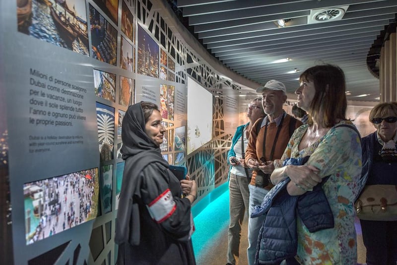 An Emirati volunteer informs visitors about the UAE. Giuseppe Aresu / The National