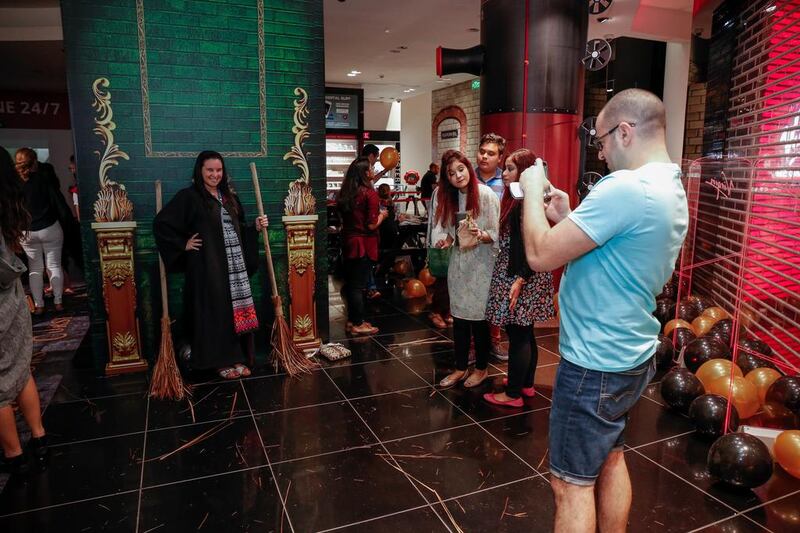 Fans pose for photos at the broomstick corner at the Harry Potter and the Cursed Child book launch at Virgin Megastore at the Mall of the Emirates. Victor Besa for The National