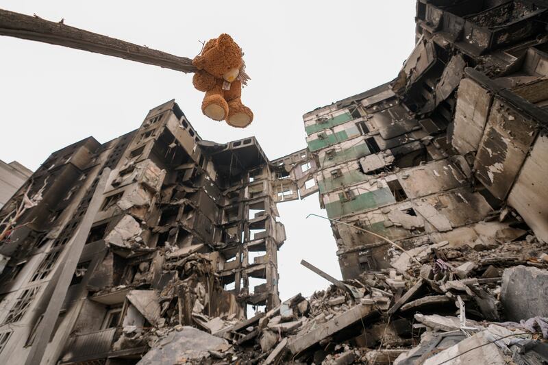 A teddy bear hangs from a tree branch outside an apartment building in Borodyanka, Kyiv oblast. AP