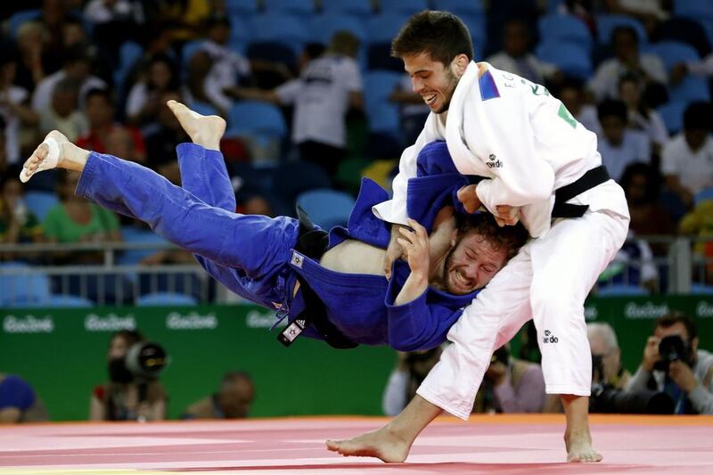 Spain’s Francisco Garrigos, in white, competes with Germany’s Tobias Englmaier during their 60kg judo contest. Jack Guez / AFP