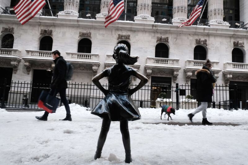 People walk by Fearless Girl statue in the New York snow in January.  Getty Images / AFP