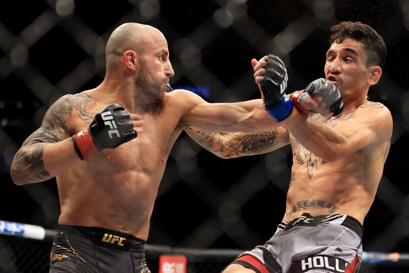 Alexander Volkanovski punches Max Holloway in their featherweight title bout during UFC 276. Getty