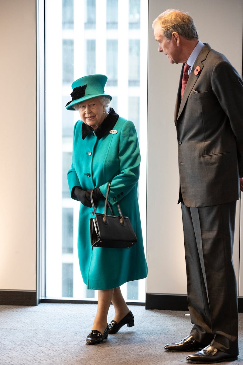 Queen Elizabeth II, wearing green, arrives to formally open the new headquarters of asset management company Schroders on November 7, 2018, in London. Getty Images