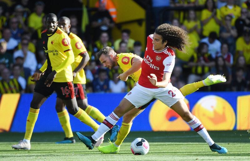 Watford's Tom Cleverley vies for the ball with Arsenal's Matteo Guendouzi. EPA