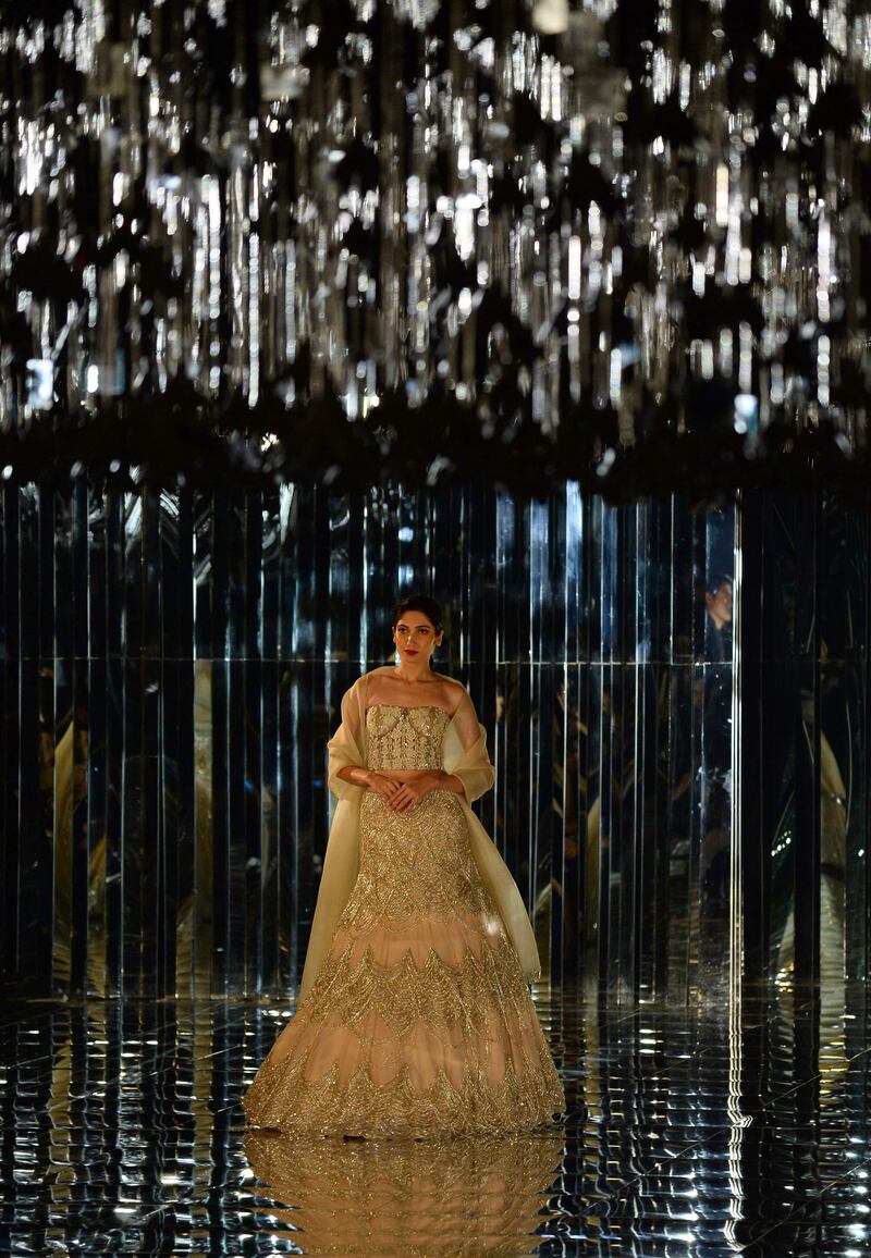 Sequins, stones, crystal and glass beads were embroidered onto outfits ranging in colour from nudes and ice greys to bottle green and crimson. AFP