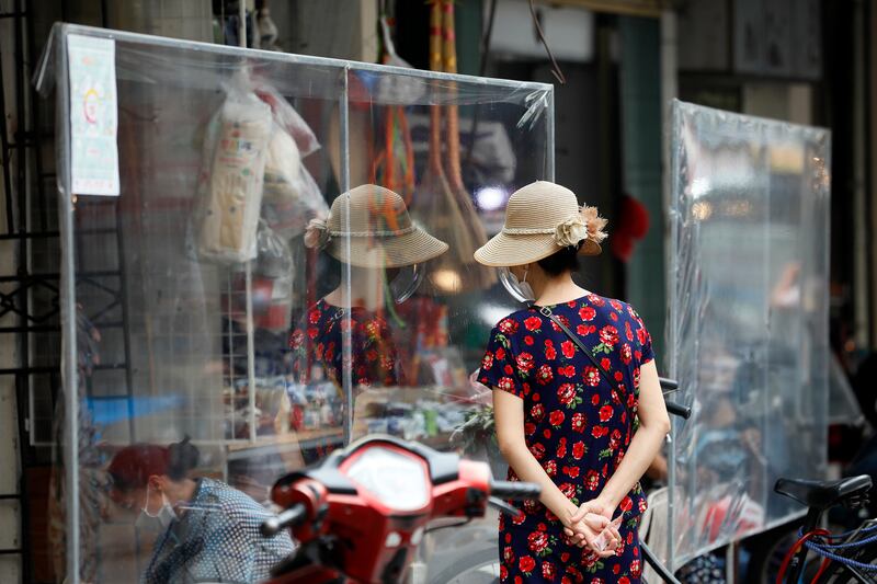 A woman shops for food at the Hang Be market in Hanoi. The city in Vietnam has relaxed social distancing measures after two months of lockdown. EPA