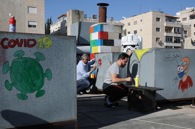 Neighbours of the Jordanian caricaturist Osama Hajjaj, team up in creating works of art on their roof  in Amman. Reuters