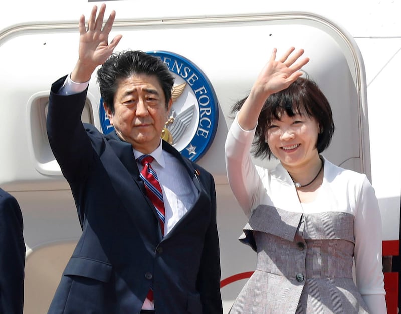 Japanese Prime Minister Shinzo Abe, left,  waves with his wife Akie Abe while boarding his plane before departure for the Middle Eastern countries, at Haneda international airport in Tokyo Sunday, April 29, 2018. (Yukie Nishizawa/Kyodo News via AP)