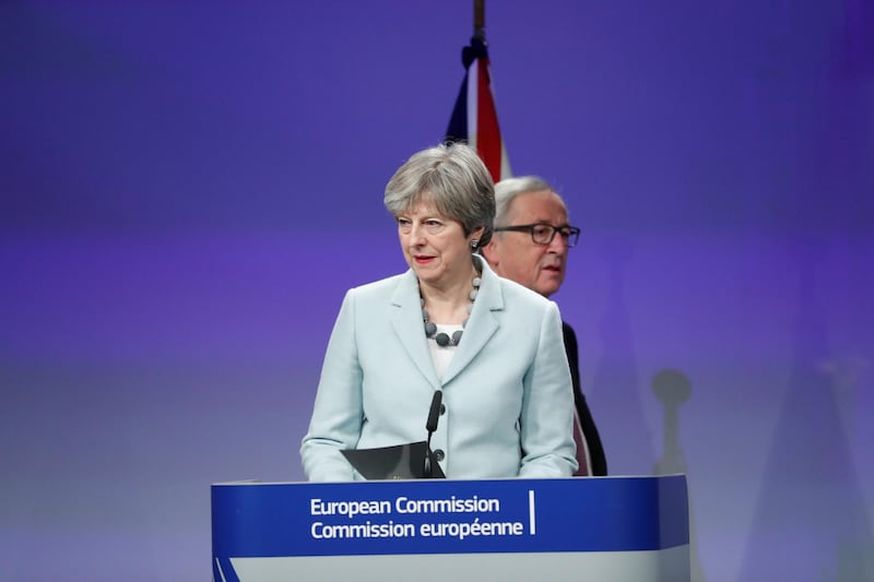Britain's Prime Minister Theresa May and European Commission President Jean-Claude Juncker speak at the EC headquarters in Brussels, Belgium December 8, 2017.  REUTERS/Yves Herman