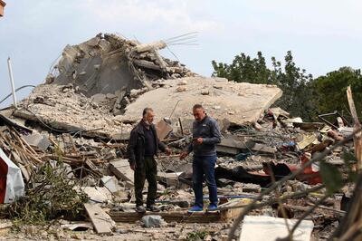 Men check the site of an Israeli air strike that targeted a house in the southern Lebanese village of Jibshit on Tuesday. AFP