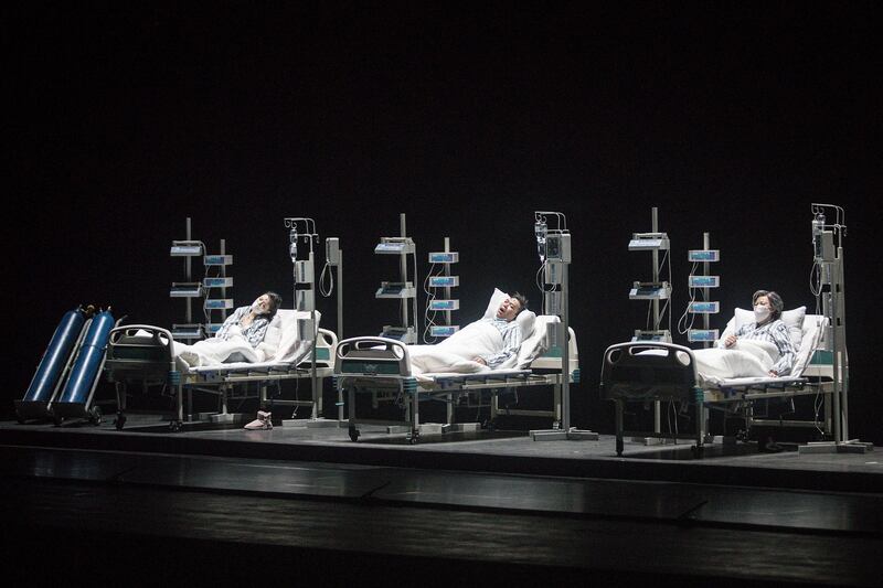 The cast perform as medical staff treating patients of Covid-19 on stage during the opera 'Angel's Diary' in Wuhan, Hubei province, China. The opera, paying tribute to medical staff, portrays a doctor rescuing coronavirus patients during the lockdown in Wuhan. Getty Images