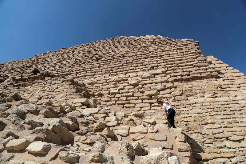 A tourist climbs the Step Pyramid. The restoration project, which began in 2006, included renovation of the pyramid exteriors and pathways. AFP