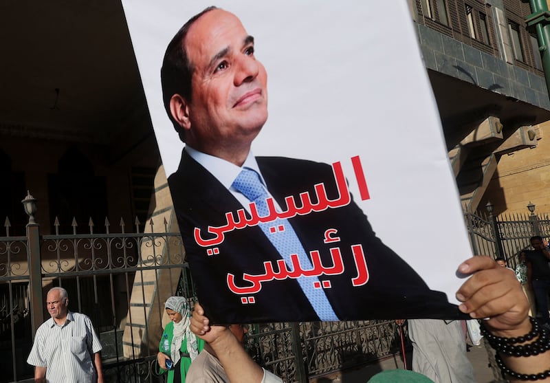 An Egyptian man carries a banner in support of President Abdel Fattah El Sisi ahead of this year's presidential election. Reuters