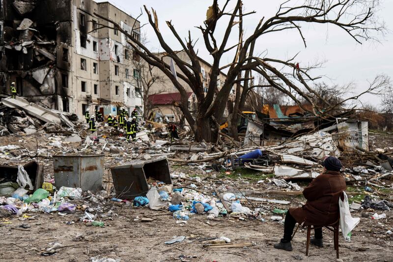 Antonina Kaletnyk waits for the body of her son in front of a collapsed building in the town of Borodianka, northwest of Kyiv. AFP