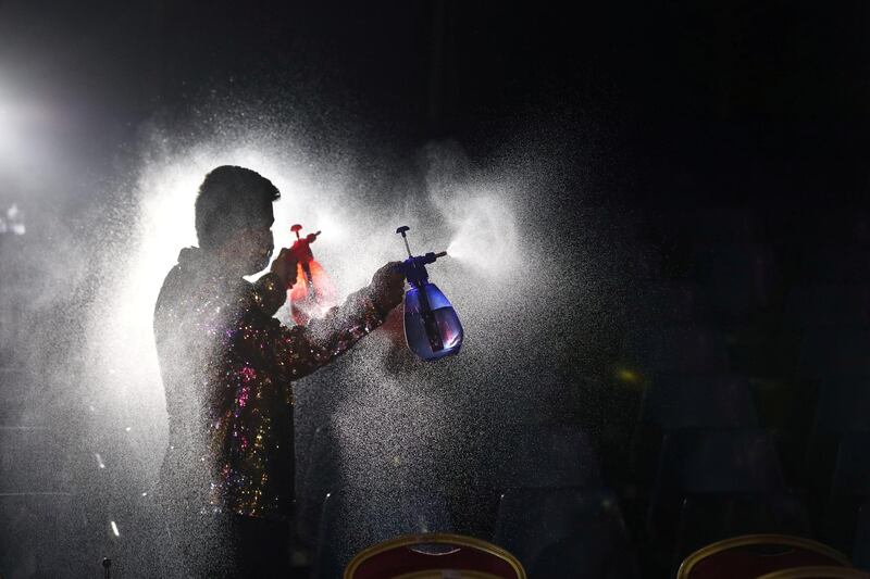 Staff member from 'Circo Pastelito' sprays disinfectant ahead of opening the circus in Santiago, Chile. Reuters