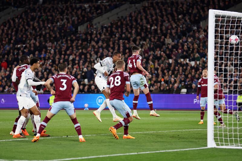 Joel Matip of Liverpool scores their second goal under pressure from Declan Rice of West Ham. Getty