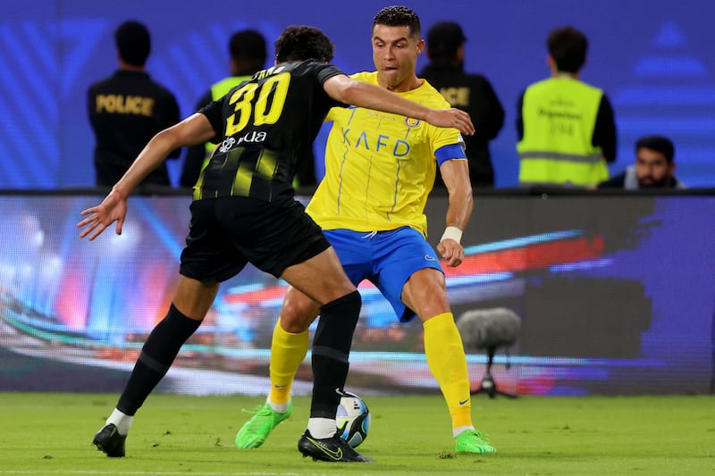 Al Ittihad defender Saad Al Mousa up against Al Nassr's Cristiano Ronaldo. AFP