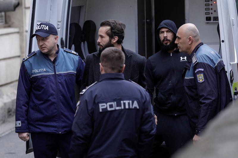 Andrew Tate, right, along with his brother Tristan, escorted by police to a Bucharest court. Reuters