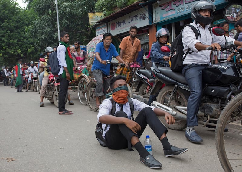 Students take position on a street to control motorists during a rally demanding safe roads on the seventh consecutive day of protests, in Dhaka city, Bangladesh.  EPA / MONIRUL ALAM