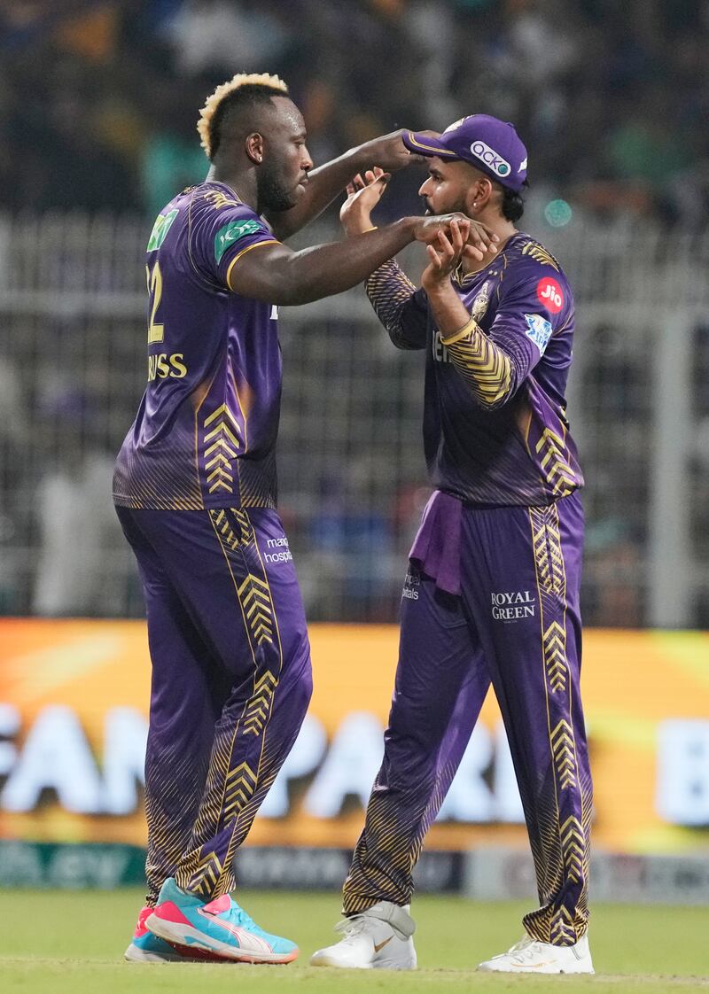 Kolkata Knight Riders' Andre Russell, left, celebrates with captain Shreyas Iyer the wicket of Royal Challengers Bengaluru's Will Jacks. AP