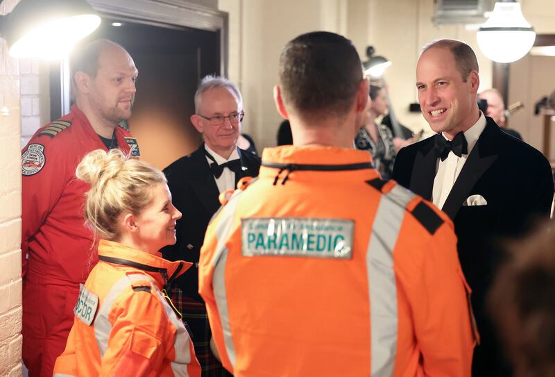 Prince William chats with air ambulance pilots, doctors and paramedics. AP