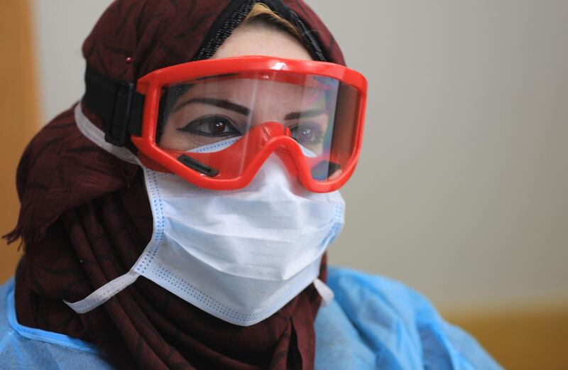 Palestinian health workers wearing a protective facemask in the courtyard of a United Nations Relief and Works Agency for Palestinian Refugees (UNRWA) school at Al Shati refugee camp in Gaza City. AFP