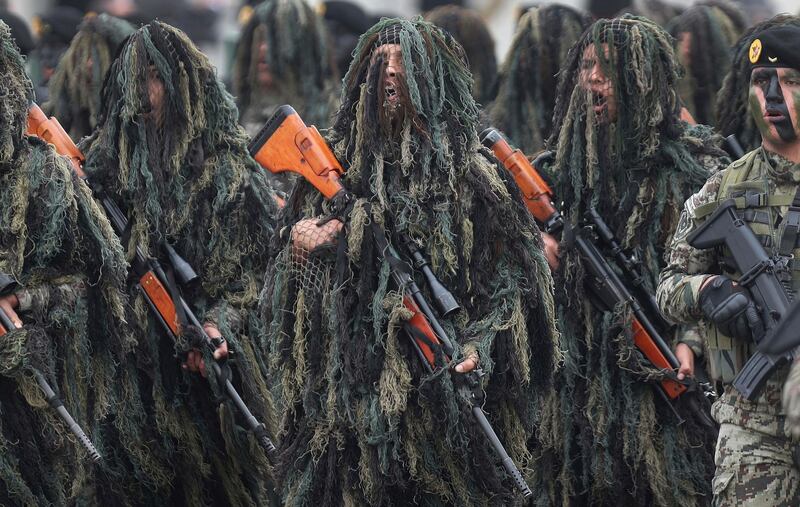 Members of the Peruvian Army Special Operations march in their Ghille suits during a military parade marking the Armed Forces' anniversary, in Lima, Peru. AP