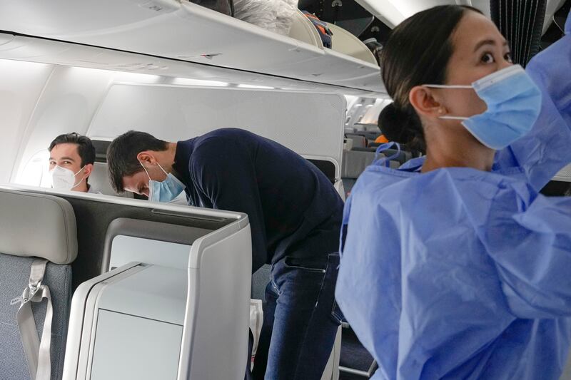 Novak Djokovic prepares to take his seat on a plane bound for Belgrade, in Dubai,. AP Photo