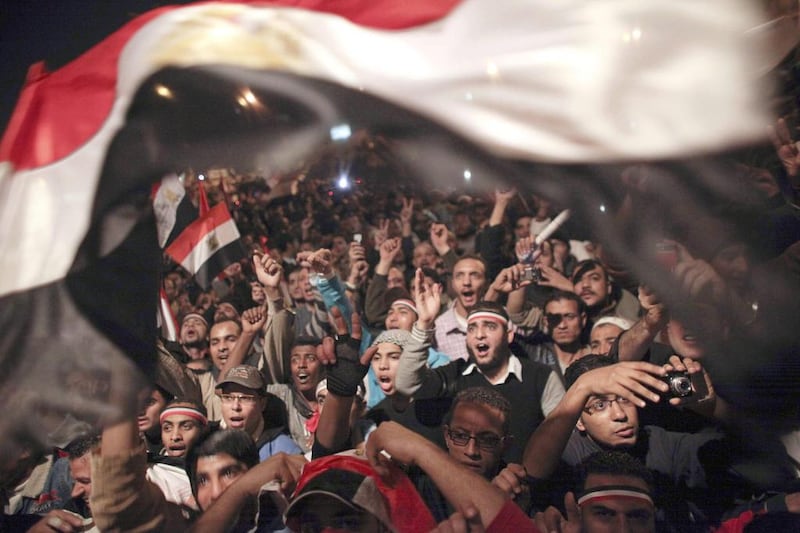 Egyptians celebrate the resignation of former president Hosni Mubarak in Tahrir Square in February 2011 / AP