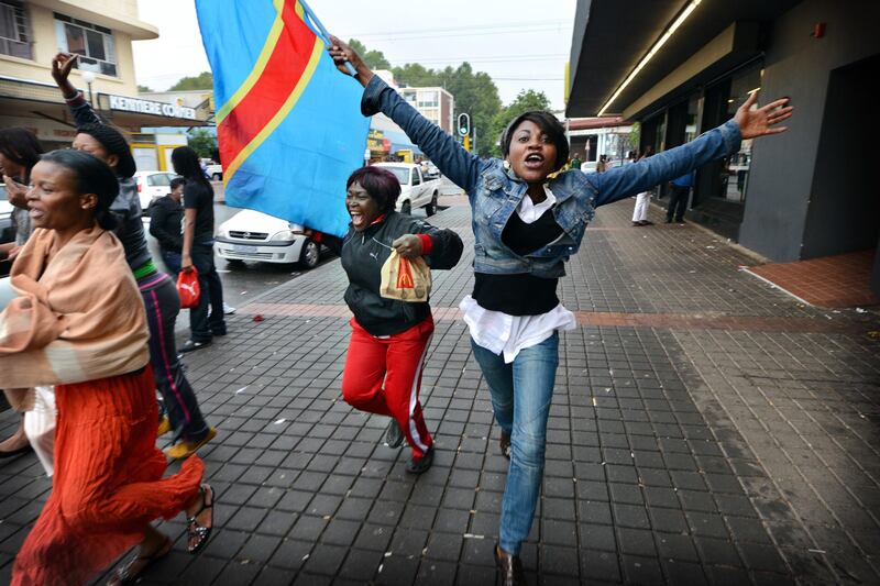 NOT FOR RESALE
JOHANNESBURG - 20130120 - Congo  supporters run the streets of Yeoville with flags after Congo was given a penalty against Ghana. 
Photo: Bram Lammers 
NOT FOR RESALE.
COPYRIGHT BRAM LAMMERS PHOTOGRAPHY
