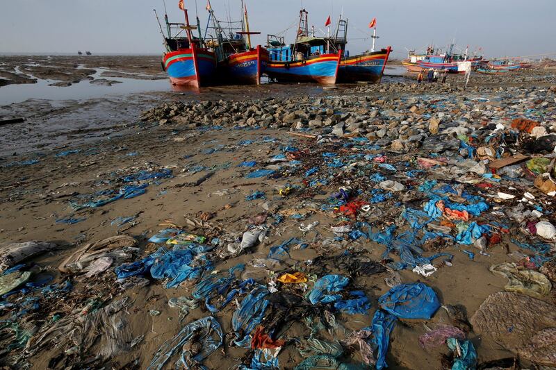 Fishing boats are seen on a beach covered with plastic waste in Thanh Hoa province, Vietnam on June 4, 2018. Nguyen Huy Kham / Reuters