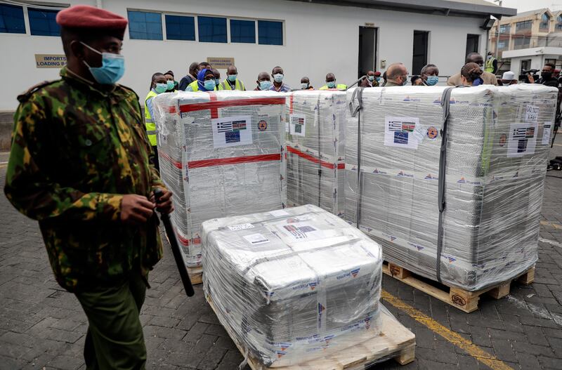 A soldier guards a shipment of 182,000 AstraZeneca doses donated via the Covax scheme, at an airport in Nairobi, Kenya. AP