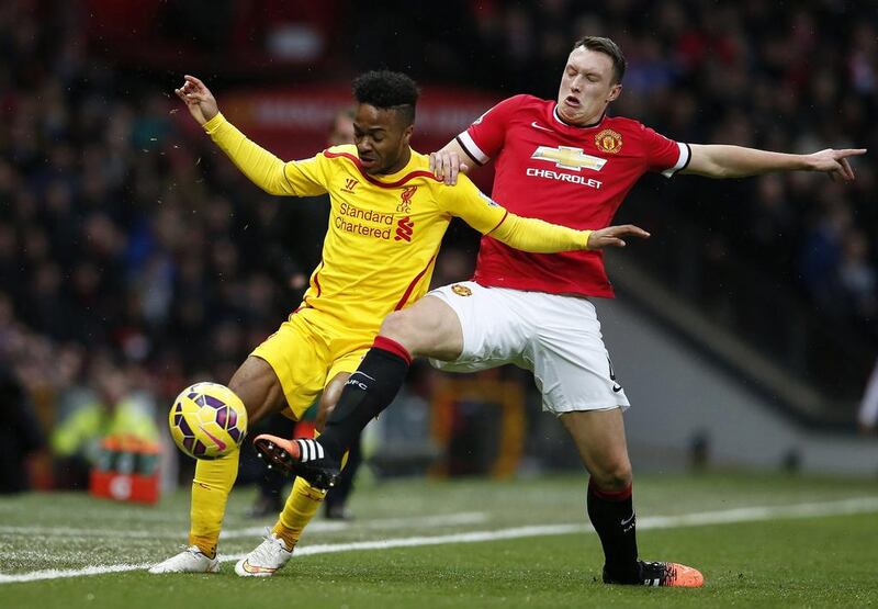 Liverpool's Raheem Sterling is challenged by Manchester United's Phil Jones on Sunday during their Premier League match. Phil Noble / Reuters