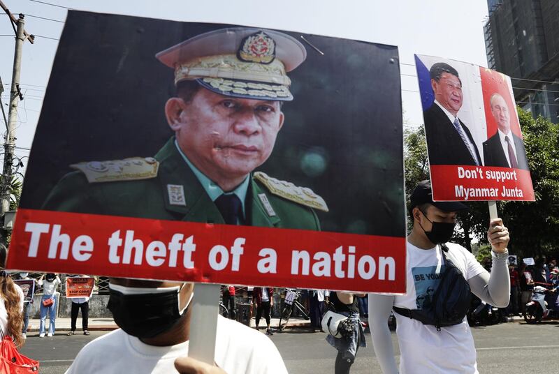 Protesters hold placards with pictures of military junta chief General Min Aung Hlaing, left, Chinese President Xi Jingping, second right, and Russian President Vladimir Putin during a protest against the military coup in Yangon. EPA