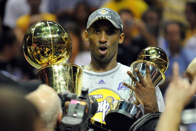 ORLANDO, FL - JUNE 14:  Kobe Bryant #24 of the Los Angeles Lakers holds up the Larry O'Brien trophy and the MVP trophy after the Lakers defeated the Orlando Magic 99-86 in Game Five of the 2009 NBA Finals on June 14, 2009 at Amway Arena in Orlando, Florida.  NOTE TO USER:  User expressly acknowledges and agrees that, by downloading and or using this photograph, User is consenting to the terms and conditions of the Getty Images License Agreement.  (Photo by Ronald Martinez/Getty Images)