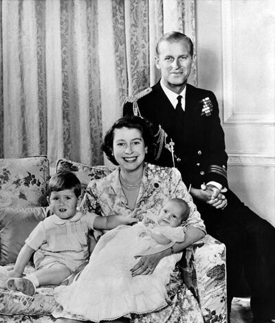 Seen here in 1951, holding the infant Princess Anne, with Prince Charles and her husband Prince Philip, the Queen wears the chrysanthemum sapphire brooch. Getty