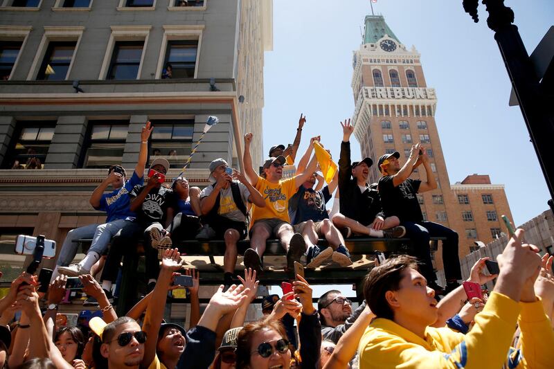 Fans cheer during the championship victory parade in downtown Oakland. The Warriors have won three of the last four NBA Championships, after a 40 year spell with no success.  Cary Edmondson / Reuters