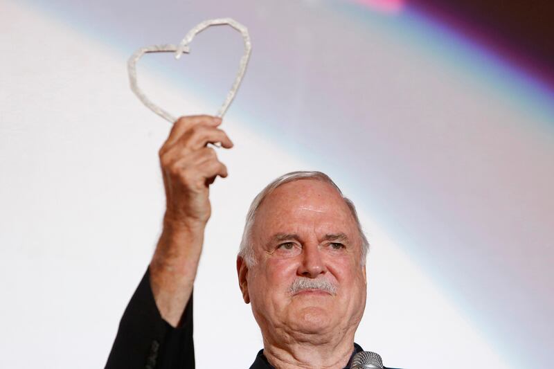 English actor John Cleese poses for photos with Sarajevo Film Festival's top honour award, the Heart of Sarajevo Award, in Sarajevo, Bosnia, on Wednesday, Aug. 16, 2017. (AP Photo/Amel Emric)