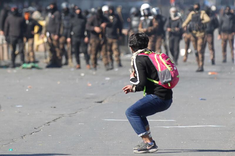 Iraqi protesters clash with riot police following an anti-government demonstration in al-Khilani Square in Baghdad.  AFP