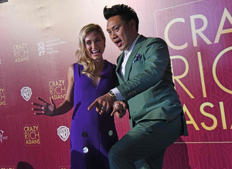 Director John M. Chu, right, and his wife Kristin Hodge arrive at the premiere of 'Crazy Rich Asians' at the Capitol Theatre in Singapore. Roslan Rahman / AFP