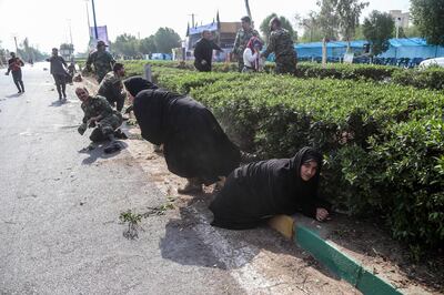 epa07038893 Iranian soldiers, women, and children lay down and run during a terror attack that occurred at military parade in the city of Ahvaz, southern Iran, 22 September 2018. Media reported that Gunmen have opened fire during an Iranian military parade in the south-western city of Ahvaz, killing several people.  EPA/MORTEZA JABERIAN