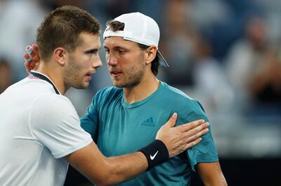 epa07305519 Lucas Pouille (R) of France is congratulated by Borna Coric (L) of Croatia after winning their men's singles fourth round match at the Australian Open Grand Slam tennis tournament in Melbourne, Australia, 21 January 2019.  EPA/RITCHIE TONGO